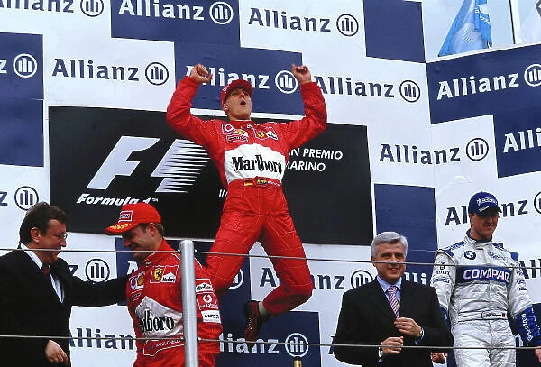 2002 San Marino Grand Prix. Imola, Italy. 12-14 April 2002. Michael Schumacher (Ferrari) celebrates his 1st position, Rubens Barrichello (Ferrari) 2nd position and Ralf Schumacher (Williams BMW) 3rd position also on the podium