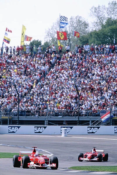 2002 United States Grand Prix Indianapolis, America. 27th - 29th eptember 2002. Michael Schumacher, Ferrari F2002, leads team mate Rubens Barrichello, action. World Copyright: Lorenzo Bellanca / LAT Photographic ref