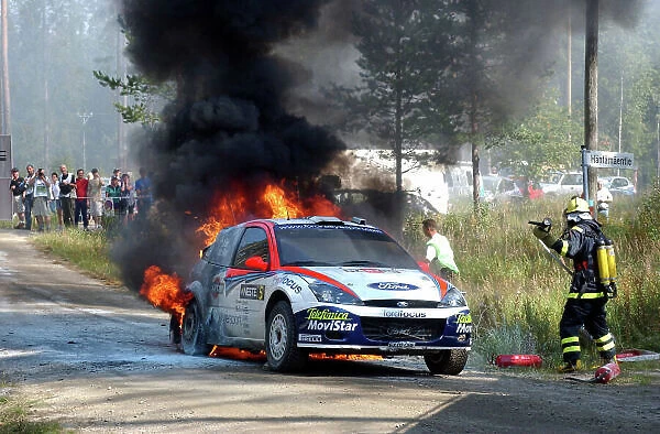 2002 World Rally Championship. Neste Rally Finland, Jyvaskyla Finland, August 8-11th. Colin McRae's Focus on fire at the end of stage 20. Photo: Ralph Hardwick / LAT