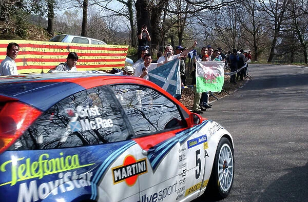 2002 World Rally Championship Rally Catalunya, 21st-24th March 2002. Colin McRae passes some British fans on his way to the second stage of Day 2. Photo: Ralph Hardwick / LAT