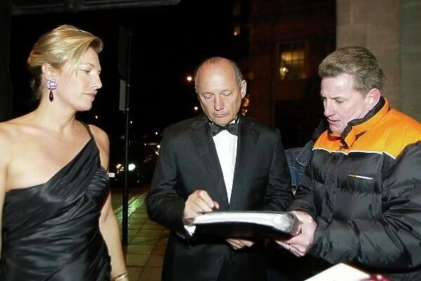 2003 AUTOSPORT AWARDS, The Grosvenor, London. 7th December 2003. Ron Dennis stops to sign an autograph. Photo: Peter Spinney / LAT Photographic Ref: Digital Image only