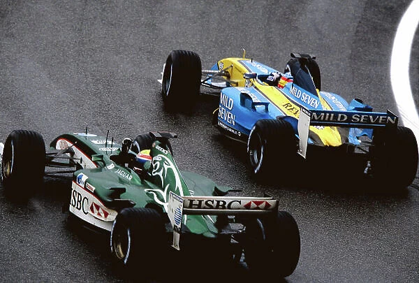 2003 Brazilian Grand Prix Interlagos, Brazil. 4th - 6th April 2003. Fernando Alonso, Renault R23, passes Mark Webber, Jaguar R4, action. World Copyright: Michael Cooper  /  LAT Photographic ref: 35mm Image 03Brazil43