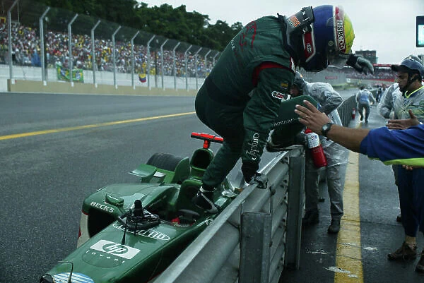 2003 Brazilian Grand Prix - Sunday Race Interlagos, Brazil. 6th April 2003. Mark Webber, Jaguar R4, gets out of his car after crashing. World Copyright LAT Photographic. ref: Digital Image Only