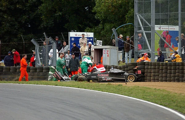 2003 British Formula Three Championship Brands Hatch, England. 27th - 28th September 2003. Marshals work to extract Lewis Hamilton from his race car, after crashing with Tor Graves