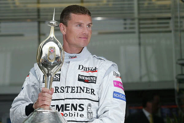 2003 British Grand Prix - Friday Qualifying, Silverstons, England. 17th July 2003. David Coulthard, West McLaren Mercedes MP4 / 17D receives the Hawthorn memorial trophy. World Copyright LAT Photographic. Digital Image Only