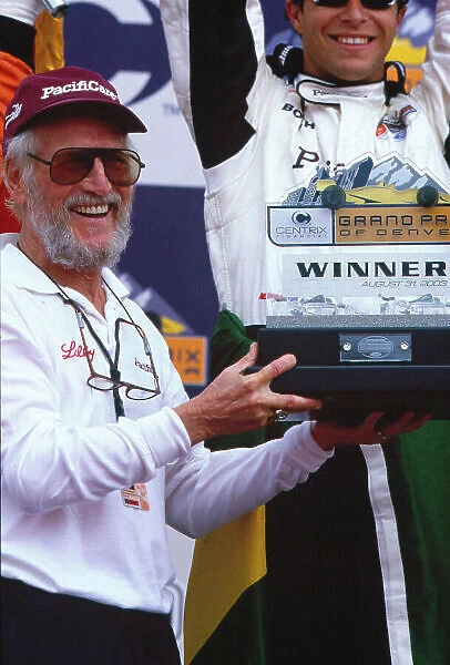 2003 Champ Car Denver Priority 2003 Champ Car World Series. 29-31 August 2003 Centrix Financial Grand Prix of Denver. Denver, Colorado. Newman / Haas team co-owner and actor Paul Newman celebrates on the podium with Bruno Junqueira