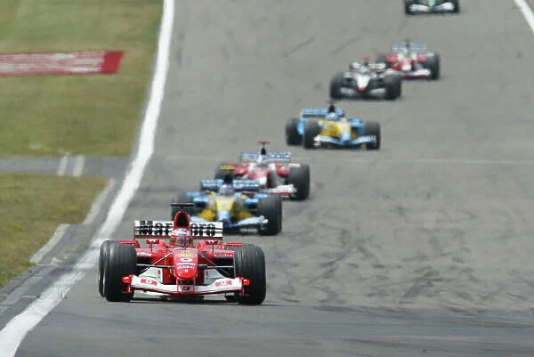 2003 European Grand Prix - Sunday race, Nurburgring, Germany. 29th June 2003. Rubens Barrichello, Ferrari F2003 GA leads Fernando Alonso, Renault R23, action. World Copyright LAT Photographic. Digital Image Only
