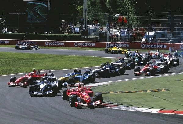 2003 Italian Grand Prix: Race start at the first corner, Michael Schumacher, Ferrari F2003 GA leads
