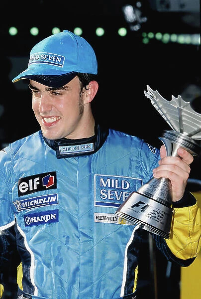 2003 Malaysian Grand Prix Sepang, Malaysia. 21st - 23rd March 2003. Fernando Alonso, Renault R23, with his 3rd position trophy. World Copyright: Steven Tee  /  LAT Photographic ref: 35mm Imahe A21