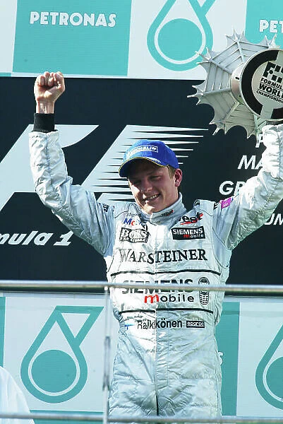 2003 Malaysian Grand Prix - Sunday race, Sepang, Malaysia. 23rd March 2003 Kimi Raikkonen, Team McLaren Mercedes MP4 / 17D, podium. World copyright LAT Photographic. ref: Digital Image Only