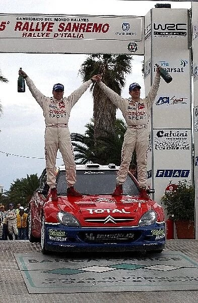 2003 Rally Sanremo: The podium: Sebastien Loeb with co-driver Daniel Elena Citroen Xsara WRC celebrate thier victory on the podium
