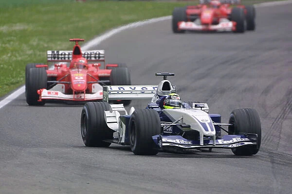 2003 San Marino Grand Prix - Sunday Race, Imola, Italy. 20th April 2003. Ralf Schumacher, BMW Williams FW25, leads Michael Schumacher, Ferrari F2002, action. World Copyright LAT Photographic. ref: Digital Image Only