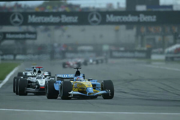 2003 United States Grand Prix - Sunday Race, Indianapolis, USA. 28th September 2003. Fernando Alonso, Renault R23, leads David Coulthard, West McLaren Mercedes MP4 / 17D, action. World Copyright LAT Photographic. Digital Image Only