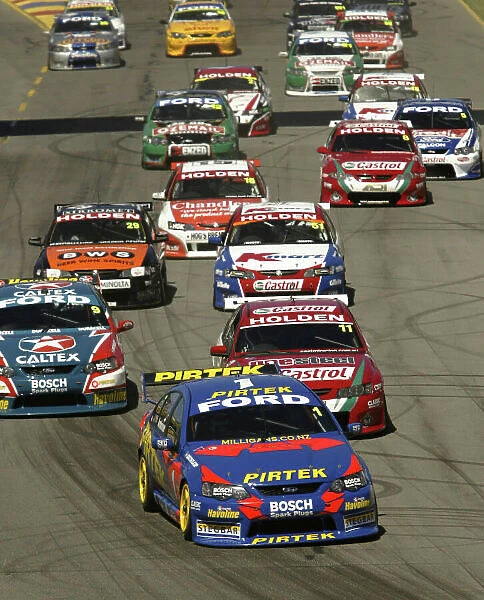 2004 Australian V8 Supercar Championship Clipsal 500, Adelaide, Australia. 21st March 2004. Ford driver Marcos Ambrose leads the field into the first corner at the start of race 2