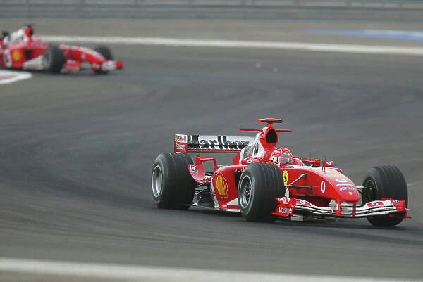 2004 Bahrain Grand Prix - Sunday race, Sakhir, Bahrain. 4th April 2004 Michael Schumcaher, Ferrari F2004, and Rubens Barrichello, Ferrari, F2004, race action. World Copyright LAT Photographic. Digital image only