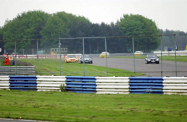 2004 British Touring Car Championship Silverstone, England. 9th May 2004. Anthony Reid (WSR MG ZS) forces Matt Neal (Team Dynamics Honda Civic Type-R) wide and onto the grass