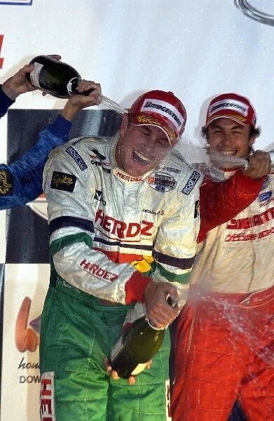 2004 Champ Car World Series: Ryan Hunter-Reay, Herdez Competition, gets doused in champagne by Patrick Carpentier, left, 2nd, and Michel Jourdain Jr