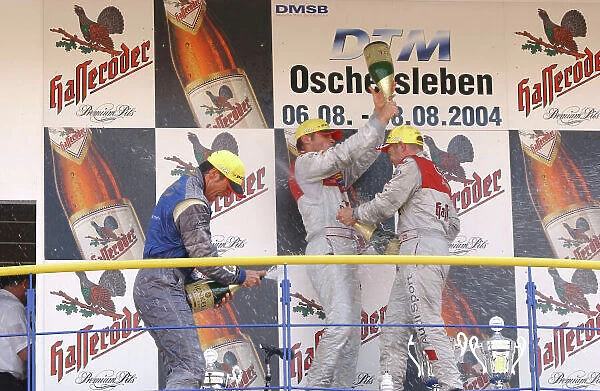 2004 DTM Championship Motopark Oschersleben, Germany. 5th - 8th August 2004. Race podium - Tom Kristensen (Abt Sportsline Audi A4) 1st, Martin Tomczyk (Abt Sportsline Audi A4) 2nd and Manuel Reuter (OPC Holzer Opel Vectra GTS) 3rd