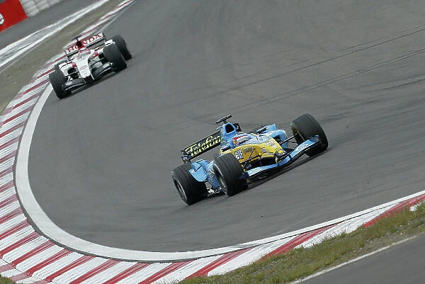 2004 European Grand Prix-Sunday Race, Nurburgring, Germany. 29th May 2004. Fernando Alonso, Renault R24 leads Takuma Sato, BAR Honda 006, race action. World Copyright: LAT Photographic. ref: Digital Image Only