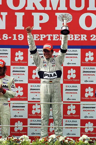 2004 Formula Nippon Championship Sepang, Malaysia. 19th September 2004 Race winner Andre Lotterer (PIAA Nakajima), podium. World Copyright: Yasushi Ishihara / LAT Photographic ref: Digital Image Only