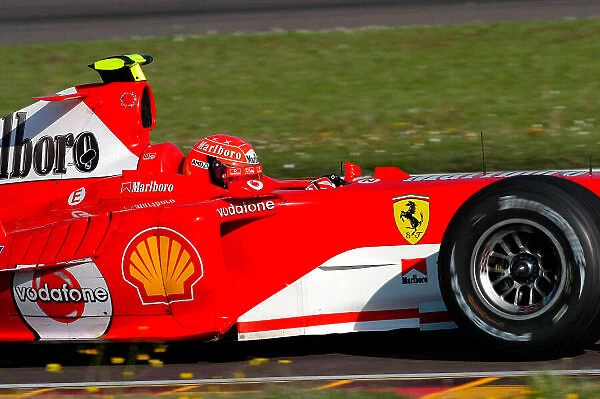 2004 Formula One Testing Fiorano, Italy. 22nd April 2004. Valentino Rossi, drives the Ferrari F2004, in what was to be a top secret test. Rossi wears one of Michael Schumacher's spare crash helmets