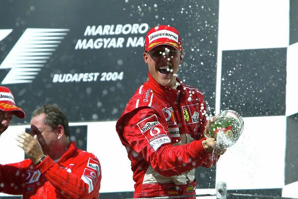 2004 Hungarian Grand Prix-Sunday Race, Hungaroring, Hungary. 15th August 2004. Michael Schumacher, Ferrari F2004, on the podium. World Copyright LAT Photographic / Michael Cooper. Digital Image only (a high res version is available on request)