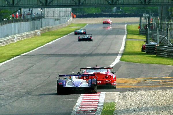 2004 Le Mans Endurance Series, Monza, Italy. 8th May 2004. The Audi Sport UK Veloqx car of Johnny Herbert hussles one of the Ferrari 550 cars.. World Copyright: Brooks / LAT Photographic. Ref: Digital Image only