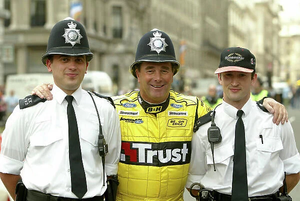 2004 Regent Street F1 Parade London, England. 6th July 2004 Nigel Mansell (Jordan) swaps hats with a London Policeman. Portrait. World Copyright: LAT Photographic ref: Digital Image Only