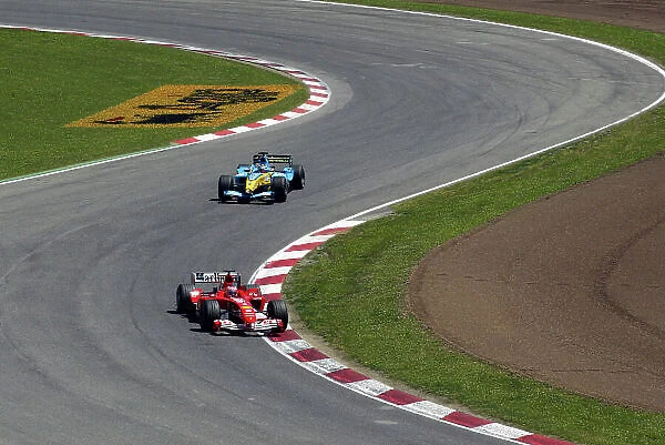 2004 Spanish Grand Prix - Sunday (Race) Circuit de Catalunya, Barcelona, Spain. 7th - 9th May. Rubens Barrichello, Ferrari F2004 leads Fernando Alonso, Renault R24. Action