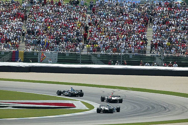 2004 United States Grand Prix-Sunday Race, Indianapolis, USA. 20th June 2003 Kimi Raikkonen, McLaren Mercedes MP4 / 19 leads Jenson Button, BAR Honda 006, race action. World copyright LAT P World copyright LAT Photographic