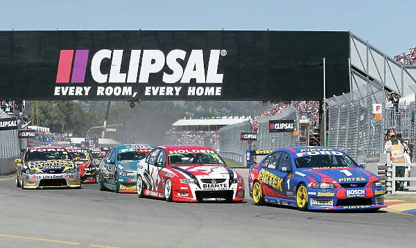 2005 Australian V8 Supercars. Clipsal 500, Adelaide, South Australia. 19th - 20th March. Marcos Ambrose (Ford Falcon BA) leads Rick Kelly (Commodore VZ) and the rest of the field into the first corner