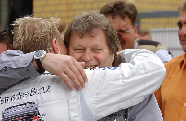 2005 DTM Championship EuroSpeedway Lausitz, Germany. 30th April - May 1st 2005. Norbert Haug congratulates Mika Hakkinen (AMG-Mercedes C-Klasse) on his third place finish