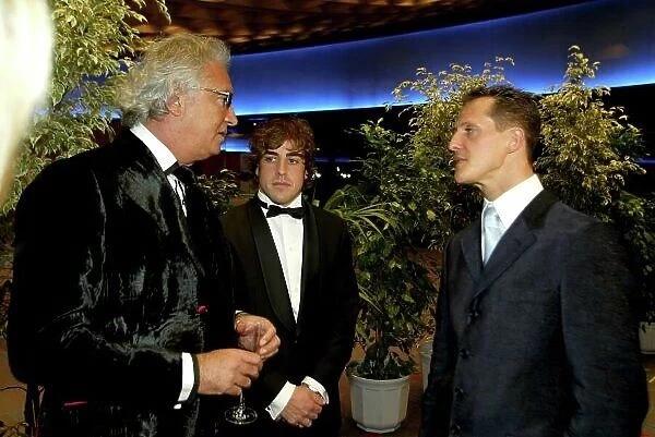 2005 FIA Awards Monaco, 9th December. Flavio Briatore with current and former World Champions Fernando Alonso and Michael Schumacher. World Copyright: Malcolm Griffiths / LAT Photographic ref: Digital Image Only