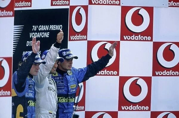 2005 Italian Grand Prix. Monza, Italy. 2nd - 4th September 2005. Juan Pablo Montoya, McLaren Mercedes MP4-20 celebrates his victory on the podium with Fernando Alonso, Renault R25 and Giancarlo Fisichella