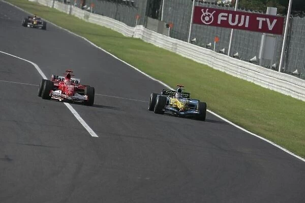 2005 Japanese Grand Prix Sunday Race, Suzuka, Japan. 9th October 2005 Fernando Alonso, Renault R25 overtakes Michael Schumacher, Ferrari F2005, Action
