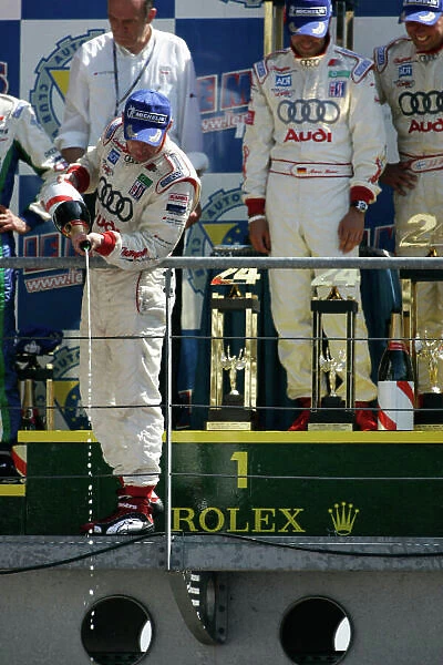 2005 Le Mans 24 Hours Le Mans, France. 17th - 18th June JJ Lehto (FIN) / Marco Werner (D) / Tom Kristensen (D) (no 3 Audi R8, Champion Racing) celebrate on the podium. World Copyright: Peter Spinney / LAT Photographic Ref: Digital image only