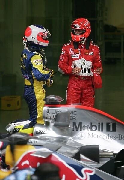 2006 Chinese Grand Prix - Saturday Qualifying, Shanghai, China. Rubens Barrichello, Honda RA106, talks to Michael Schumacher, Ferrari 248F1, in parc ferme after qualifying 3rd and 6th respectively