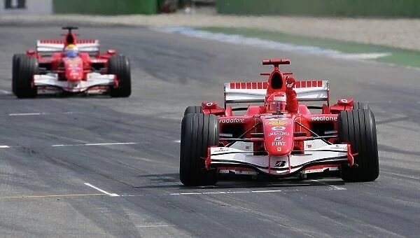 2006 German Grand Prix - Sunday Race, Hockenheim, Germany. Michael Schumacher, Ferrari 248F1, 1st position, crosses the finish line followed by Felipe Massa, Ferrari 248F1, 2nd position
