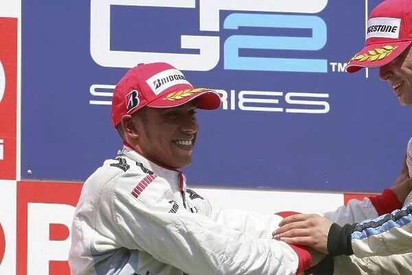 2006 GP2 Series. Round 10. Istanbul Park, Istanbul Turkey. 27th August 2006. Sunday Race. Andreas Zuber (AUT, Trident Racing) celebrates his victory on the podium with Lewis Hamilton (GBR, ART Grand Prix)