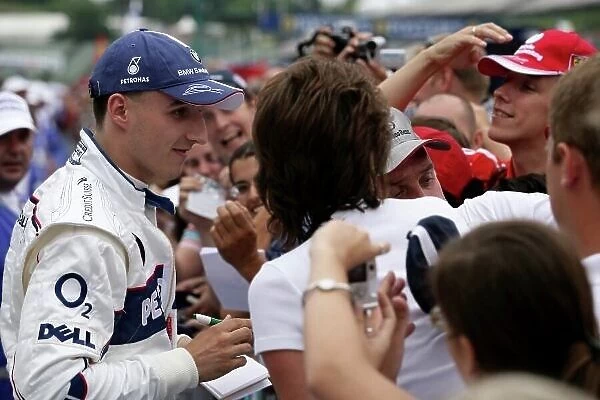 2006 Hungarian Grand Prix - Thursday Preview Hungaroring, Budapest, Hungary. 3rd - 6th August. Robert Kubica, BMW Sauber F1.06 signs autographs for fans. Portrait. World Copyright: Charles Coates / LAT Photographic ref: Digital Image ZK5Y2793