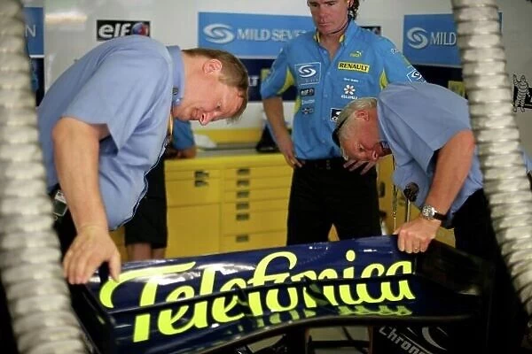2006 Malaysian Grand Prix - Friday Practice Sepang, Kuala Lumpur. Malaysia. 15th March 2006 FIA Technical Delegates Charlie Whiting and Jo Bauer check the rear wing of the Renault R26 in response to accusations about the Ferrai 248 F1's wing in