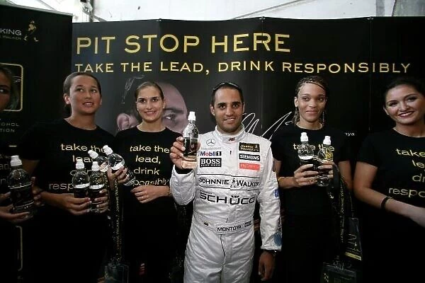 2006 Monaco Grand Prix - Wednesday Preview Monte Carlo, Monaco. 23rd - 28th May. Juan Pablo Montoya, McLaren MP4-21 Mercedes takes part in Johnnie Walker's Drink Responsibly campaign at Monaco train station. World Copyright