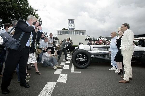 2007 Goodwood Revival Press Day. Goodwood, West Sussex. 18th July 2007. Sir Stirling Moss, Marilyn Monroe and Lord March, with The Essolube Girls, by a Napier Railton and 2 bi-planes