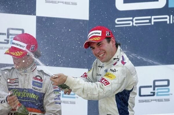 2007 GP2 Series. Round 11. Valencia, Spain. 30th September. Sunday Race. Timo Glock (GER, iSport International) celebrates winning the 2007 GP2 Series title on the podium with Javier Villa (ESP, Racing Engineering)