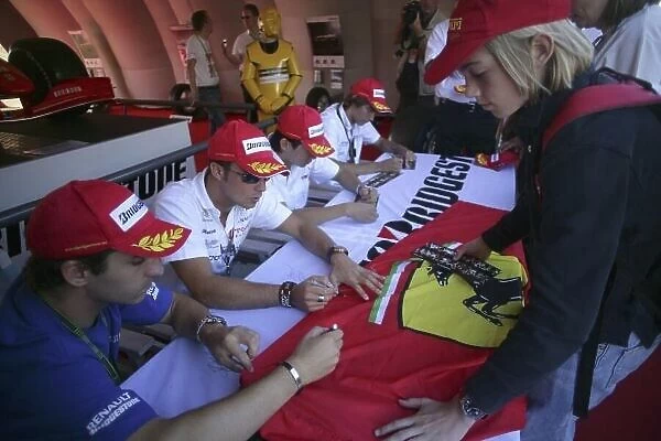 2007 GP2 Series. Round 6. Nurburgring, Germany. 21st July 2007. Saturday Race. Timo Glock (GER, iSport International) and Andreas Zuber (GER, iSport International) sign a fans flag