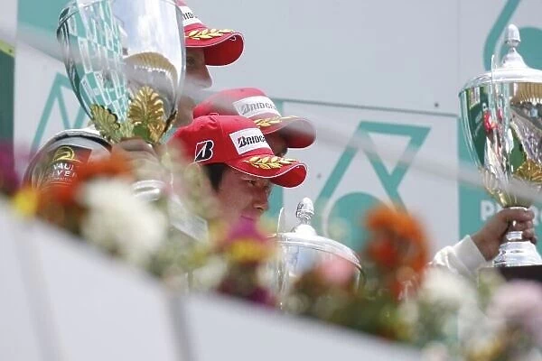 2008 GP2 Asia Series. Round 3. Sunday Race. Sepang, Kuala Lumpur. Malaysia. 23rd March. Kamui Kobayashi (JPN, Dams) celebrates his victory on the podium. World Copyright: Glenn Dunbar / GP2 Series Media Service ref:__O9T6938.jpg