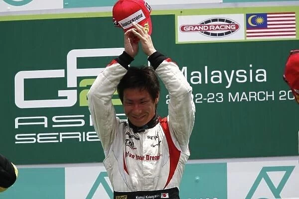 2008 GP2 Asia Series. Round 3. Sunday Race. Sepang, Kuala Lumpur. Malaysia. 23rd March. Kamui Kobayashi (JPN, Dams) celebrates victory on the podium. World Copyright: Andrew Ferraro / GP2 Series Media Service ref:__H0Y7357.jpg