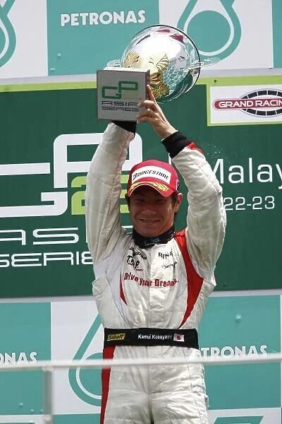 2008 GP2 Asia Series. Round 3. Sunday Race. Sepang, Kuala Lumpur. Malaysia. 23rd March. Kamui Kobayashi (JPN, Dams) celebrates victory on the podium. World Copyright: Andrew Ferraro / GP2 Series Media Service ref:__H0Y7364.jpg
