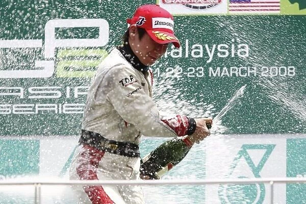 2008 GP2 Asia Series. Round 3. Sunday Race. Sepang, Kuala Lumpur. Malaysia. 23rd March. Kamui Kobayashi (JPN, Dams) celebrates victory on the podium. World Copyright: Andrew Ferraro / GP2 Series Media Service ref:__H0Y7389.jpg