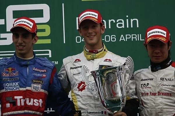 2008 GP2 Asia Series. Saturday Race. Bahrain International Circuit. Sakhir, Bahrain. 5th April. Romain Grosjean (FRA, ART Grand Prix) celebrates victory on the podium with Sebastien Buemi (SUI, Trust Team Arden) and Kamui Kobayashi (JPN, Dams)